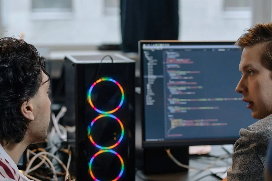 A sleek modern workspace with two computer screens showing web design projects, underscoring technology and productivity.
